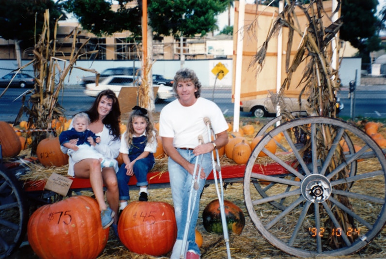 Lisa Vanderpump and Ken Todd and their two kids pose for the camera at a pumpkin patch.