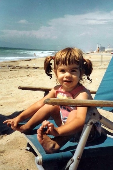 Katie Maloney sits on a beach chair at the beach while she was a little girl.