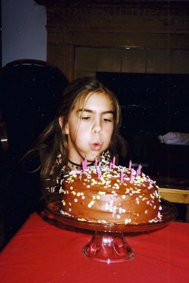 Katie Maloney blows out the candles on a birthday cake from when she was younger.