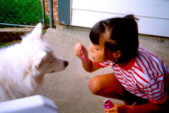 Kristen Doute blows bubbles at a dog.