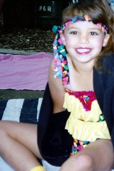 Scheana Shay wears a colorful outfit as a young child.