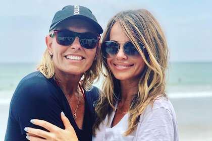 Captain Sandy Yawn posing with Leah Shafer while wearing sunglasses and smiling at the beach.