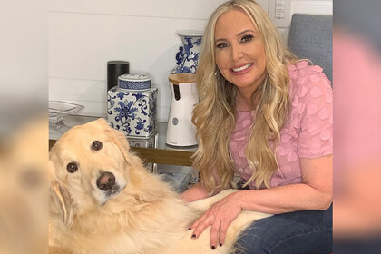 Shannon Beador sitting on a couch with her dog Archie.