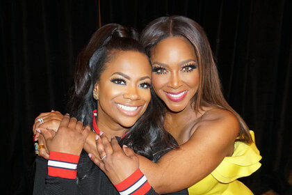Kenya Moore and Kandi Burruss happy together at an event.
