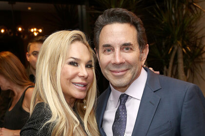 Adrienne Maloof and Paul Nassif pose for a photo together.