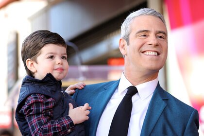 Andy Cohen and son Ben at a red carpet event.