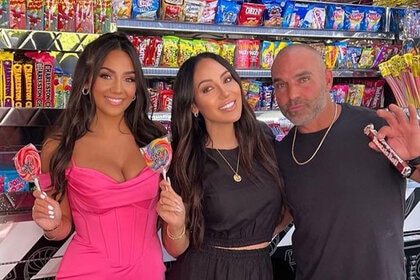 Melissa Gorga, Joe Gorga, and Antonia Gorga pose together with desserts in front of a candy truck.