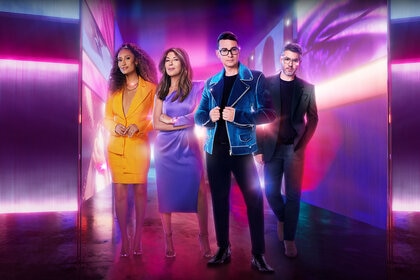 The Project Runway judges pose in front of a chromatic backdrop.