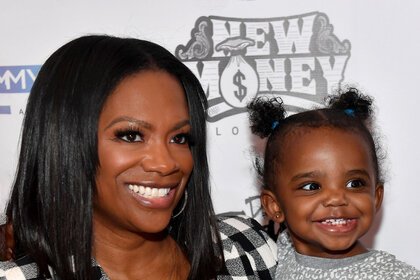 Kandi Burruss and Blaze Tucker pose for a photo together while on a red carpet.