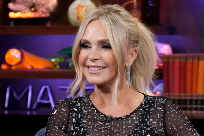 Tamra Judge smiling with an updo wearing a jeweled jumpsuit.