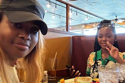 Dr. Heavenly Kimes and her daughter Alaura at a restaurant table.
