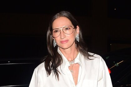 Jenna Lyons wearing diamond earrings and a white button down top in NYC.