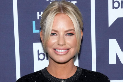 Caroline Stanbury smiling in front of the WWHL step and repeat in New York City.