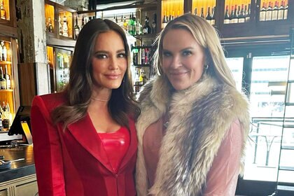 Meredith Marks posing with Heather Gay in front of a bar at a restaurant.