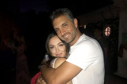 Farrah Aldjufrie and Mauricio Umansky embracing each other while out together.