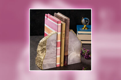 Books within 2 agate bookends on a table with trinkets overlaid onto a colorful background.