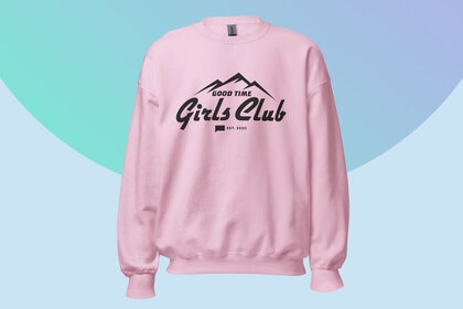 A pink sweatshirt with a quote on it overlaid onto a colorful background.