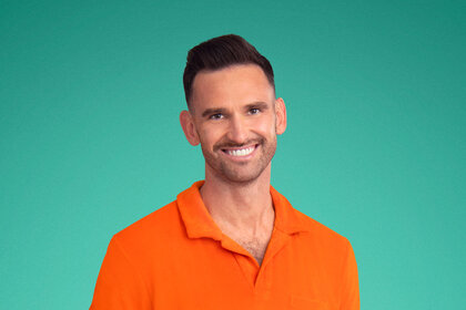 Carl Radke wearing an orange polo in front of a green backdrop.