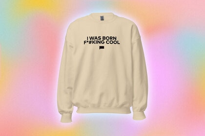 A sweatshirt with a quote printed onto it overlaid onto a colorful background.
