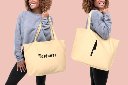 A model holding a large tote back with Top Chef written on it and also a knife illustration on it.