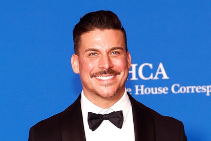 Jax Taylor smiling in front of a step and repeat.