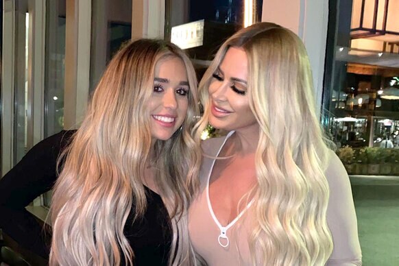 Ariana Biermann wearing a black long sleeve top and Kim Zolciak Biermann wearing a beige v neck top, out together.