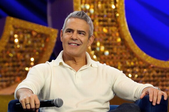 Andy Cohen smirks during a panel at BravoCon 2023
