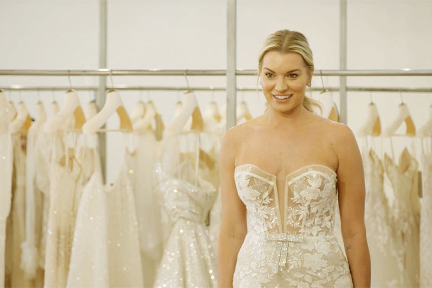 Lindsay Hubbard smiling in the mirror in her wedding dress.