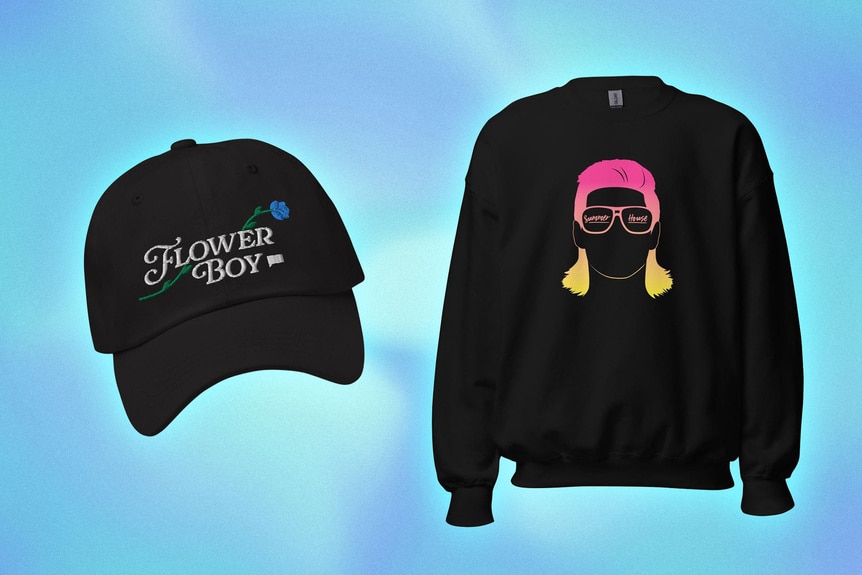 A baseball cap and sweatshirt with graphics and quotes on them overlaid onto a colorful background.