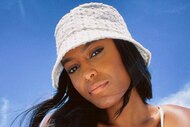 Ciara in a white bucket hat at the beach.