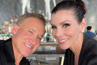 Heather and Terry in all black, smiling, together at a restaurant.