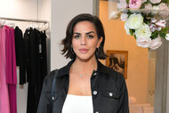 Katie Maloney posing in a black and white outfit inside of a clothing store.