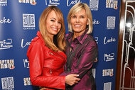 Leah Shafer, wearing a red jacket, smiling and posing with Captain Sandy Yawn who is wearing a purple blouse.