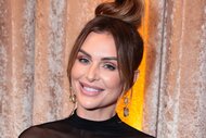 Lala Kent smiling in a black, mesh, dress in full glam and a top bun.