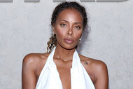 Eva Marcille of The Real Housewives of Atlanta poses in a white dress.