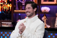 Craig Conover of Southern Charm wears a white jacket while a guest on Watch What Happens Live.