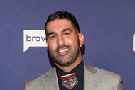 Rod Razavi posing in front of a step and repeat at BravoCon 2023.