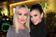 Taylor Armstrong and Heather Dubrow posing together inside of a restaurant.