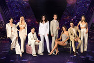 The cast of Vanderpump Rules Season 11 dressed in neutral and beige tones in a purle room overlooing LA.