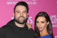 Scheana Shay and Mike Shay posing together in front of a step and repeat.