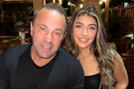 Joe Guidice and Gia Guidice of The Real Housewives of New Jersey smile in matching black outfits.