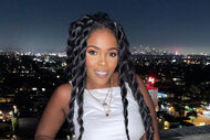 Jasmine Goode wearing a white top with twists in her hair on a balcony overlooking LA