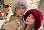 Scheana Shay and Lala Kent pose together in front of a white Christmas tree.