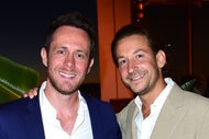 David Parnes and James Harris posing and smiling next to each other at an event.