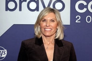 Captain Sandy Yawn smiling in front of a step and repeat at BravoCon 2023.