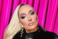 Erika Jayne posing in front of a pink curtain.