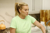 Lindsay Hubbard washes dishes as she has a conversation with her roommate.
