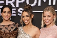 Katie Maloney, Scheana Shay, and Ariana Madix posing next to each other in front of a step and repeat.
