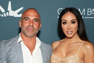 Melissa Gorga and Joe Gorga posing in front of a step and repeat.