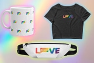 A coffee mug, a waist puch, and a black tee on a rainbow background.
